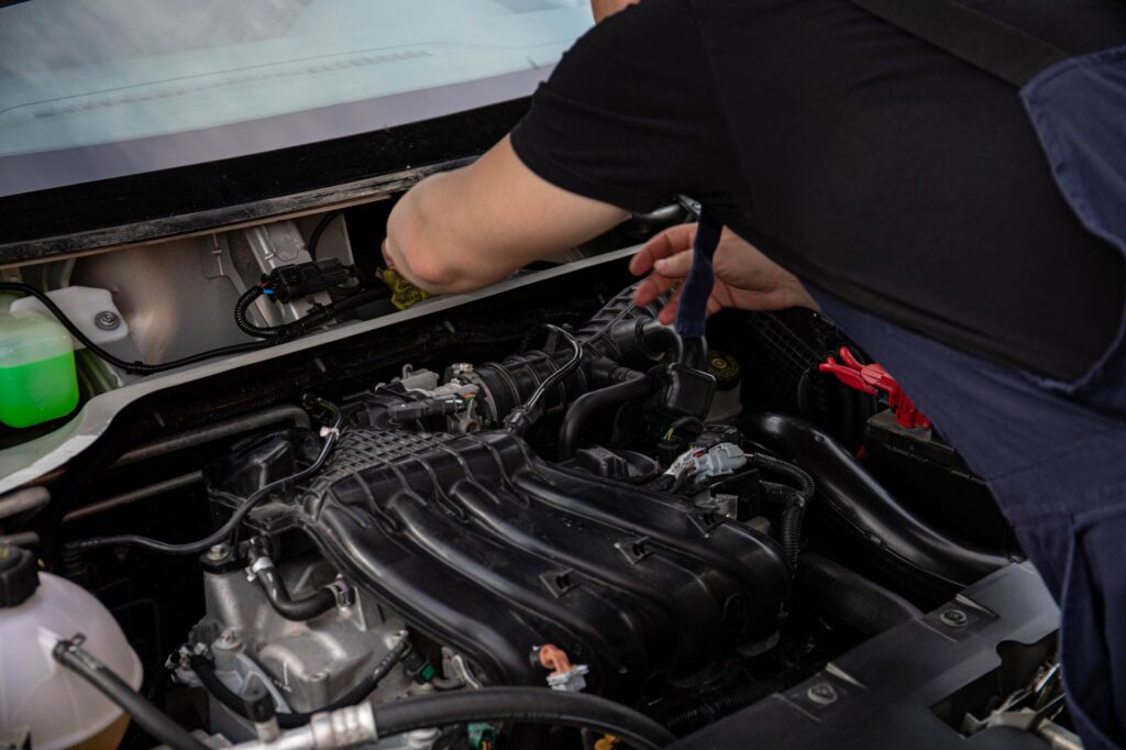 Mechanik pracujący przy silniku samochodowym Kia